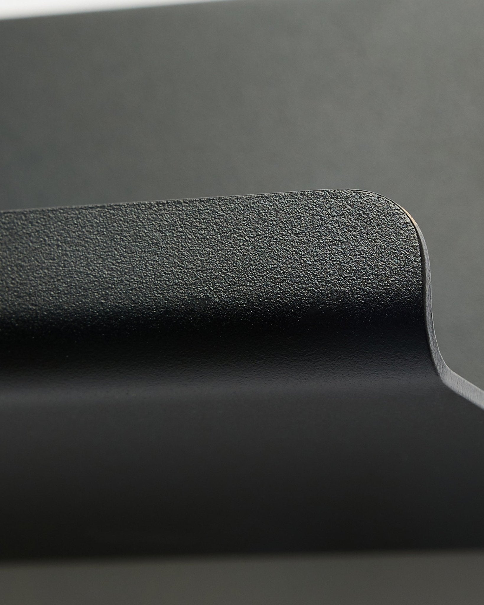 Norr | Wide Shelf von WoodUpp in black, 75,9 cm, mit strukturierter, geschwungener Kante und minimalistischem nordischem Design vor einem glatten grauen Hintergrund.